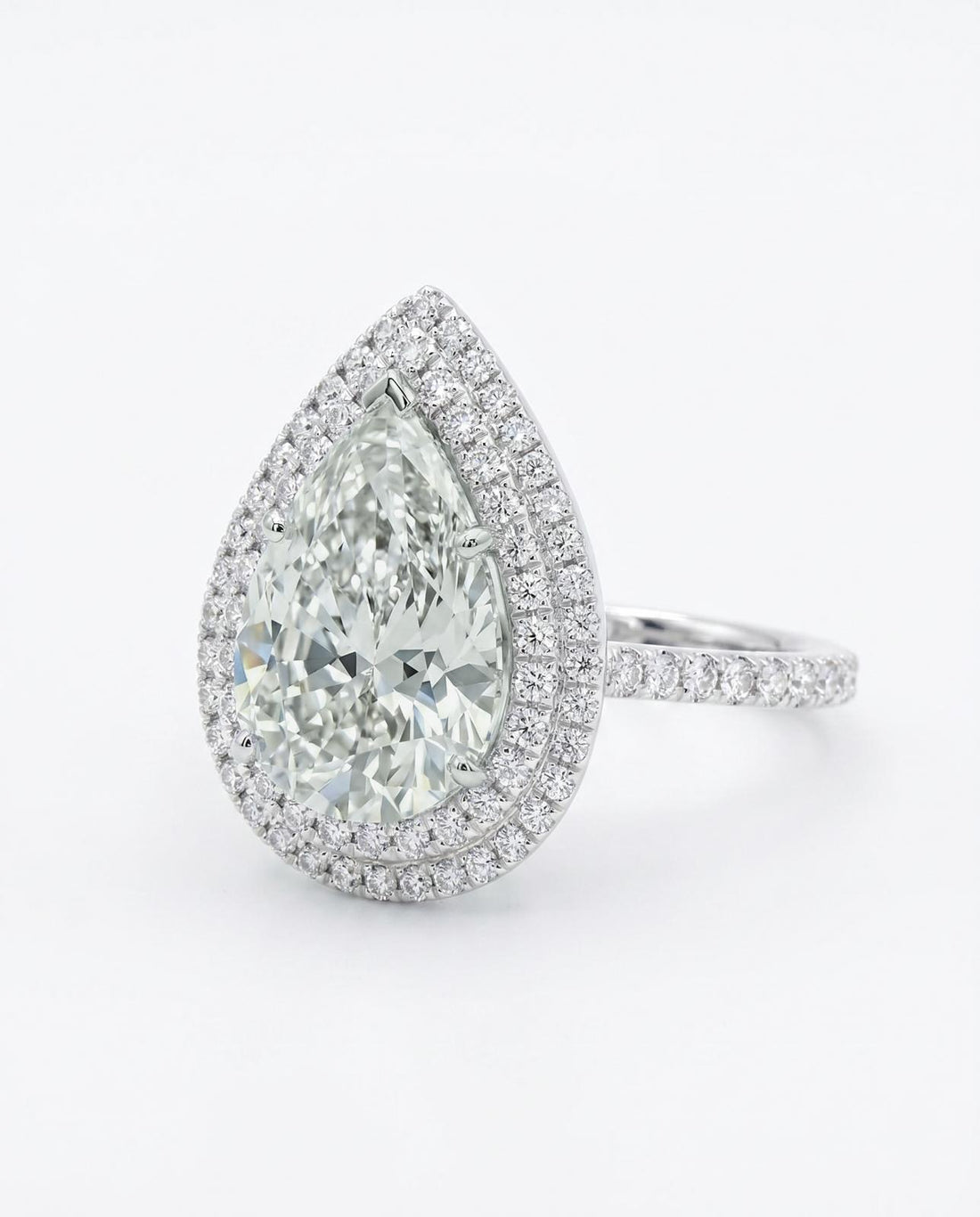 7.03 Ct Pear Diamond, Natural, K SI2 set with 1.18Ct Dia, 18k Gold
