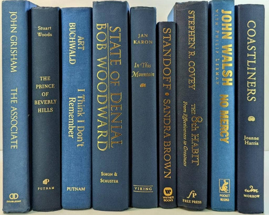 Blue books with gold  titles by the foot for decor